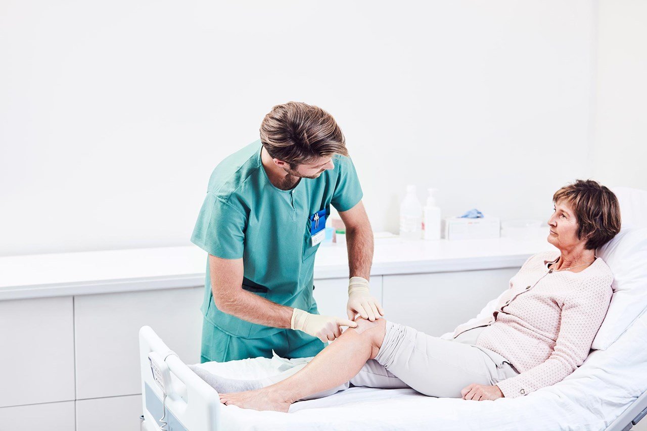 Nurse dressing a wound on a boy's arm